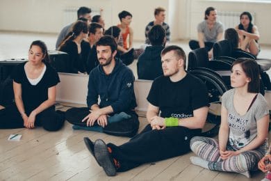 Students sit in circle listening