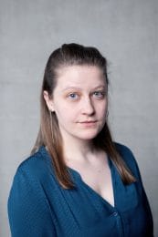 Angie Goddard. A woman with blue eyes wearing a blue top